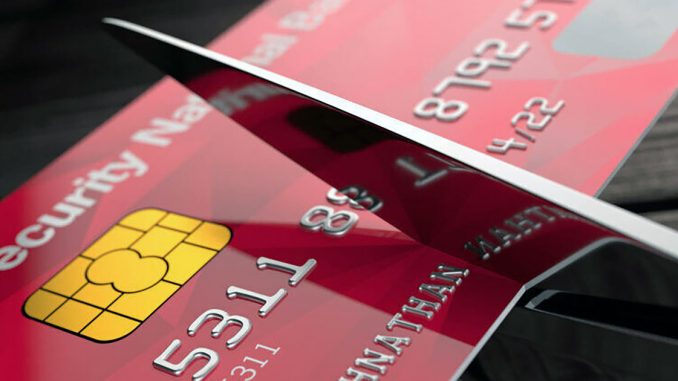 Goodbye to credit card debt Credit card being cut