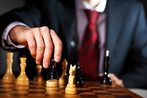leadership-strategy Leadership strategy illustrated by businessman playing chess game.